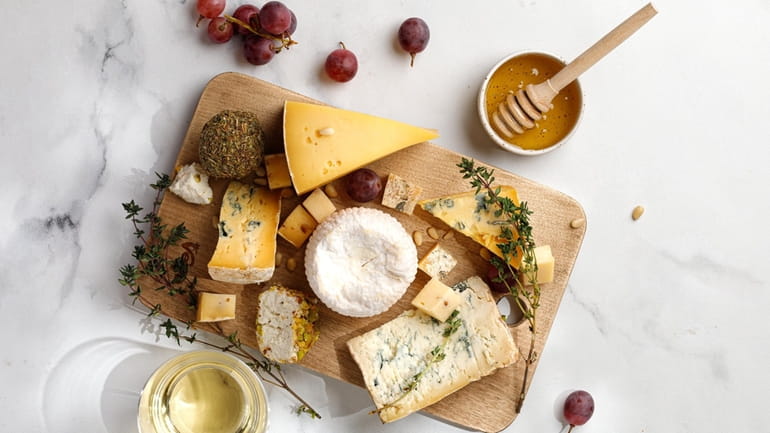 A cheese board features Shropshire, Langres, Asiago, Gorgonzola and shanklish cheese...