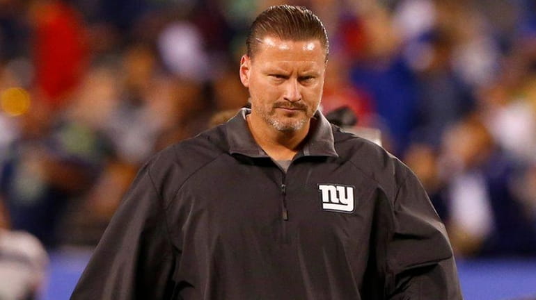 Ben McAdoo of the Giants walks off the field after...