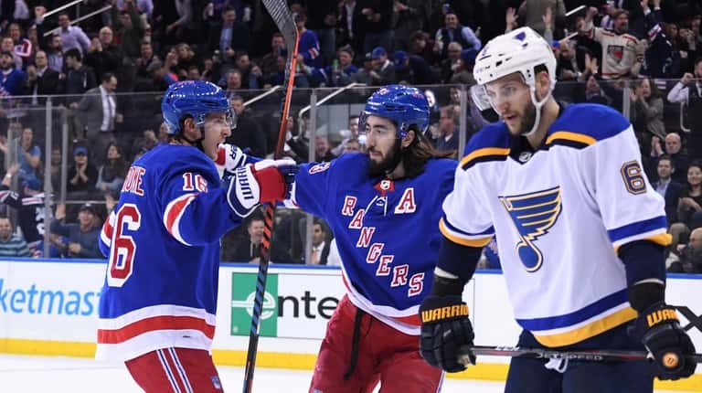 New York Rangers center Mika Zibanejad, center, is congratulated by...