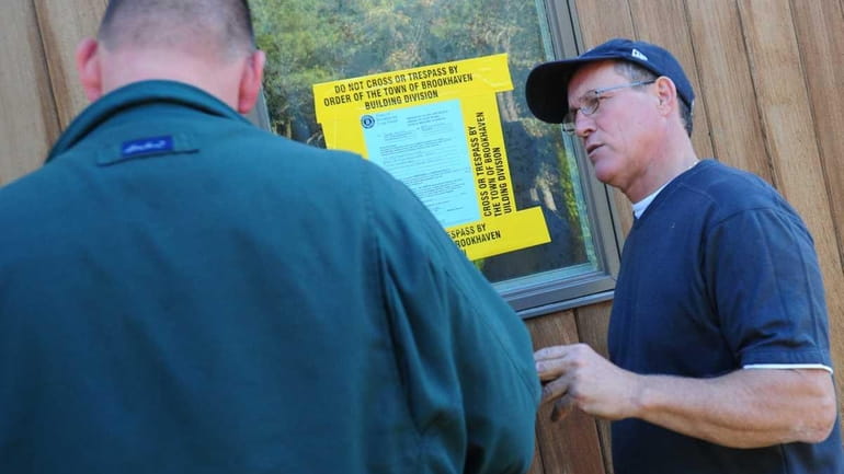 Tom Busiello, right, speaks with a Town of Brookhaven building...