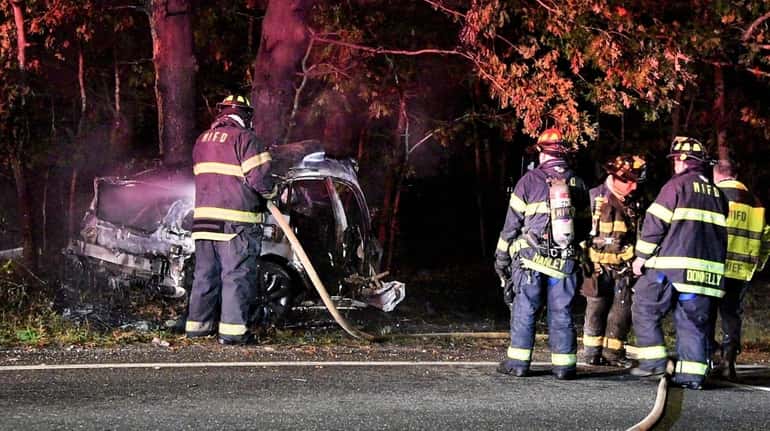 Firefighters at the scene of a fatal single-car crash on...