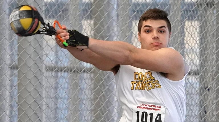 Nick Pisciotta of Commack wins the weight throw with a...