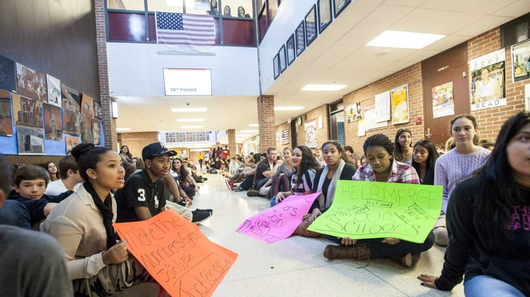 Students sit in the front hallway at Southampton High School...