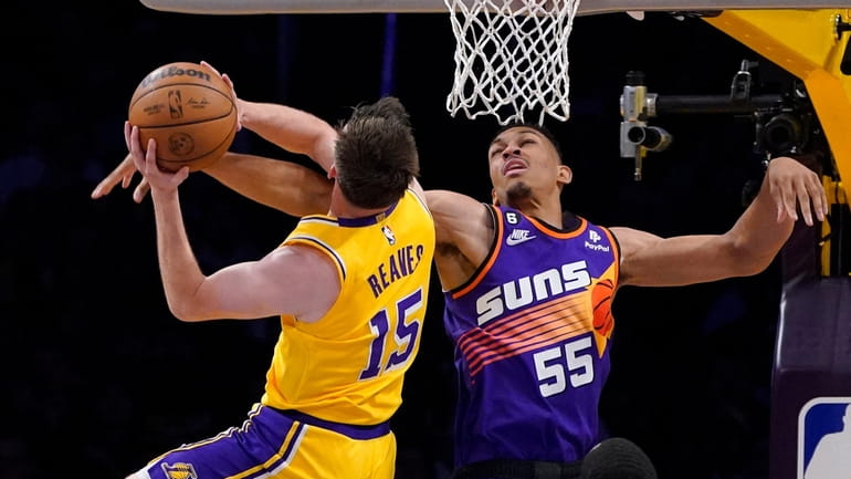 Los Angeles Lakers guard Austin Reaves, left, shoots as Phoenix...