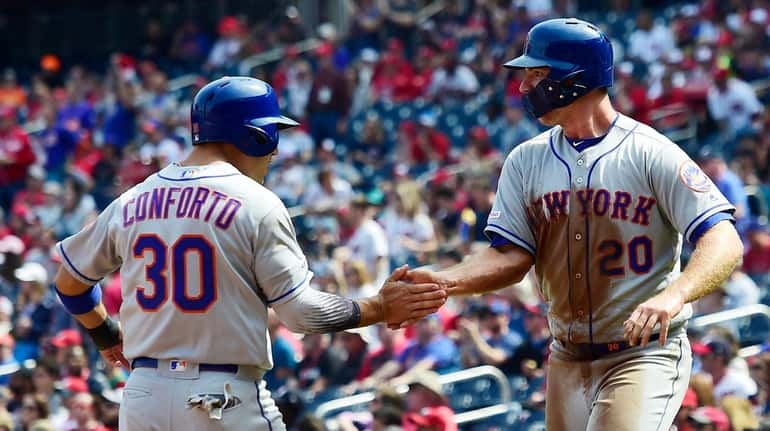 Michael Conforto and Pete Alonso of the Mets celebrate after...