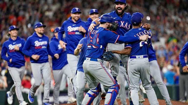 The Texas Rangers celebrate after Game 7 of the baseball...