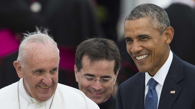Pope Francis waves alongside President Barack Obama upon arrival at...