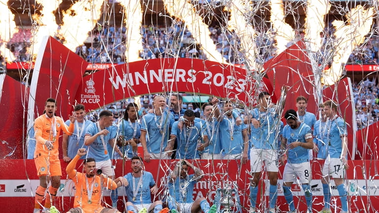 Manchester City players celebrate after winning the English FA Cup...