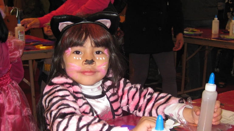 Young girl enjoying a Halloween event at the Westbury Library....