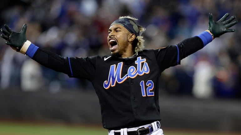 Francisco Lindor #12 of the Mets celebrates his tenth inning game...