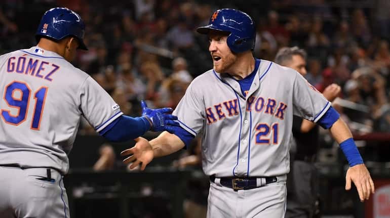 Todd Frazier of the Mets celebrates with teammate Carlos Gomez...