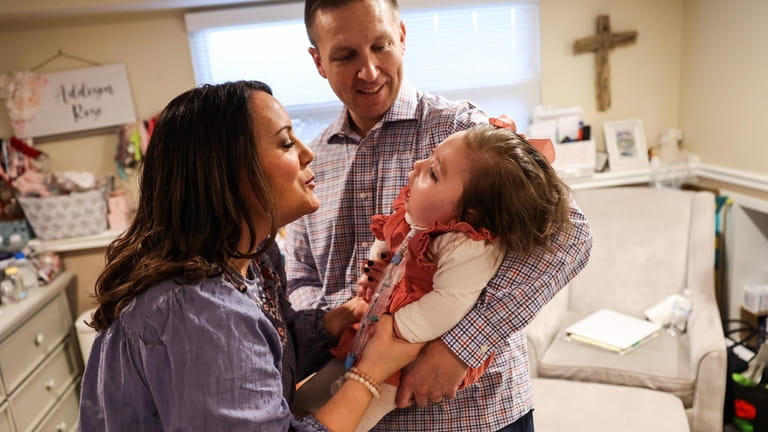 Nicole White and husband Ryan with their 18-month-old daughter, Addison, whose underlying...