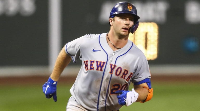 Pete Alonso of the Mets rounds third base after hitting a two-run...