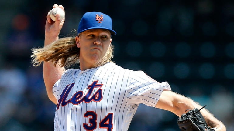 Mets pitcher Noah Syndergaard delivers during the first inning against the...