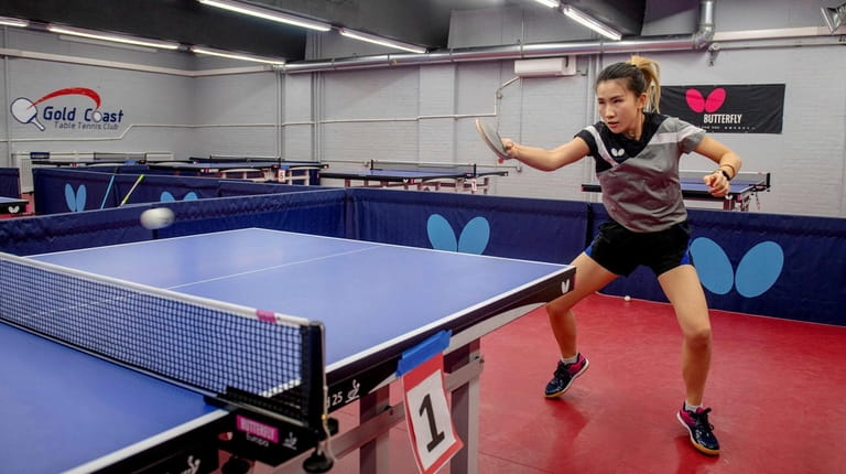 World-class table tennis instructor Fei Zhai, co-owner of the club,...