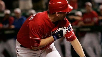 Texas Rangers' Jeff Francoeur is hit by a pitch by...