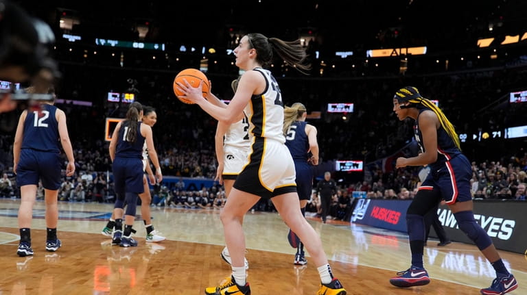 Iowa guard Caitlin Clark (22) celebrates in front of UConn...