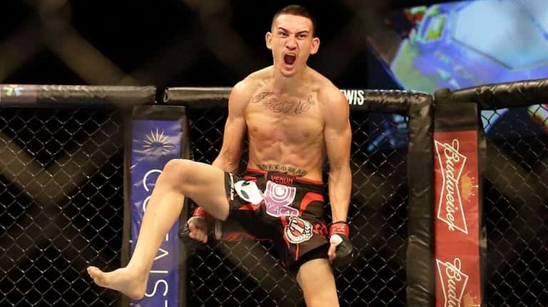 Max Holloway reacts after defeating Will Chope during their UFC...