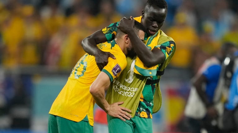 Australia's Aziz Behich, left, and Awer Mabil, right, react at...