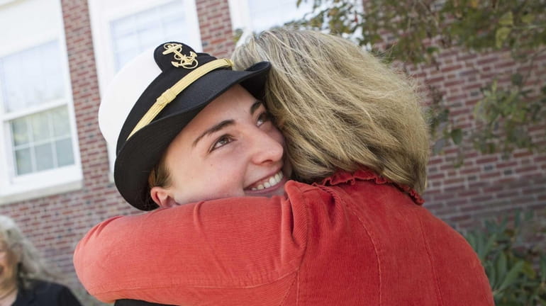 Cadet Shelby Pickerell, 16 from Southold, gets a hug from...