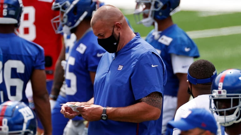 New York Giants offensive line coach Marc Colombo looks on...