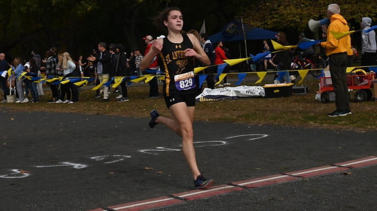 Kiera Udell of St. Anthony's crosses the finish line in...