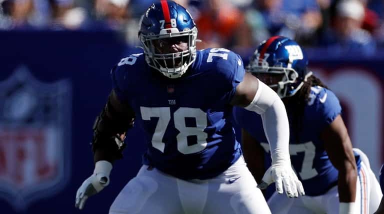 Giants offensive tackle Andrew Thomas blocks against the Falcons during an...