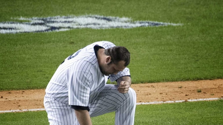 Yankees pitcher Joba Chamberlain is struck with a broken bat...
