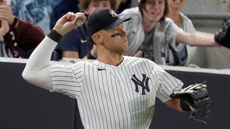 Aaron Judge of the Yankees throws the ball back in after...