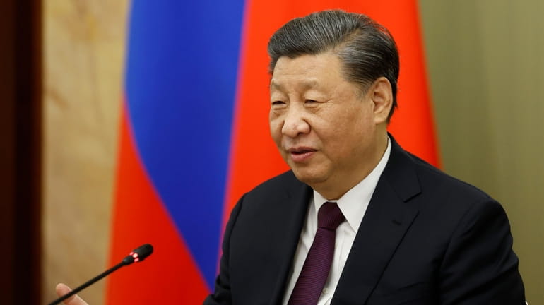 Chinese President Xi Jinping gestures while speaking to Russian Prime...