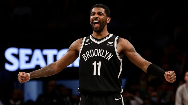 Kyrie Irving of the Brooklyn Nets reacts after a basket during...