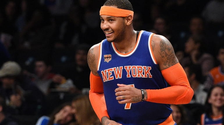 The Knicks' Carmelo Anthony reacts after sinking a three-point shot...