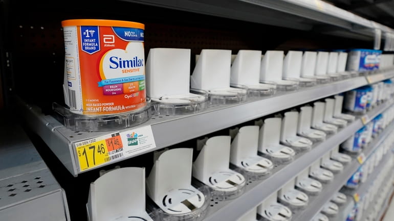 Shelves typically stocked with baby formula sit mostly empty at...