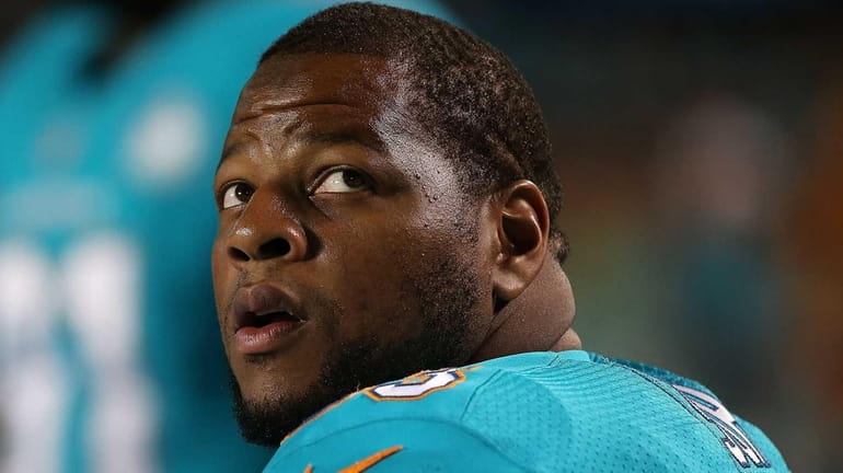 Ndamukong Suh of the Miami Dolphins looks on during a...