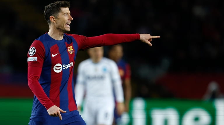 Barcelona's Robert Lewandowski gestures during the Champions League, round of...