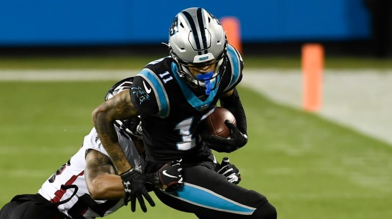 Panthers wide receiver Robby Anderson is tackled by Falcons cornerback...