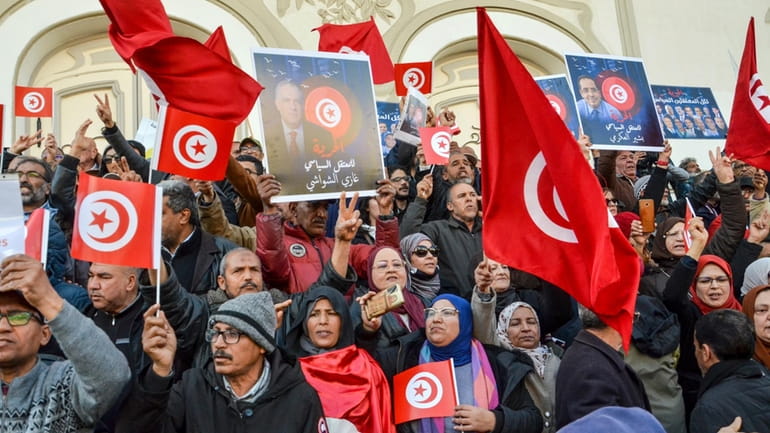 People take part in a protest against president Kais Saied...