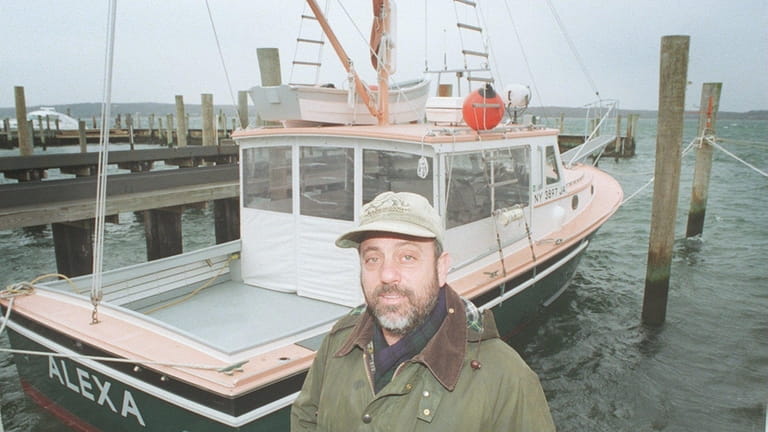Singer Billy Joel at dockside with his lobster boat, "Alexa."