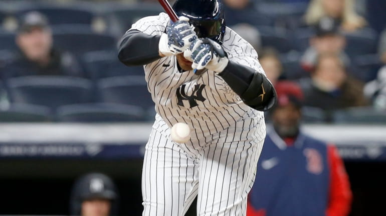Gleyber Torres #25 of the New York Yankees is hit...