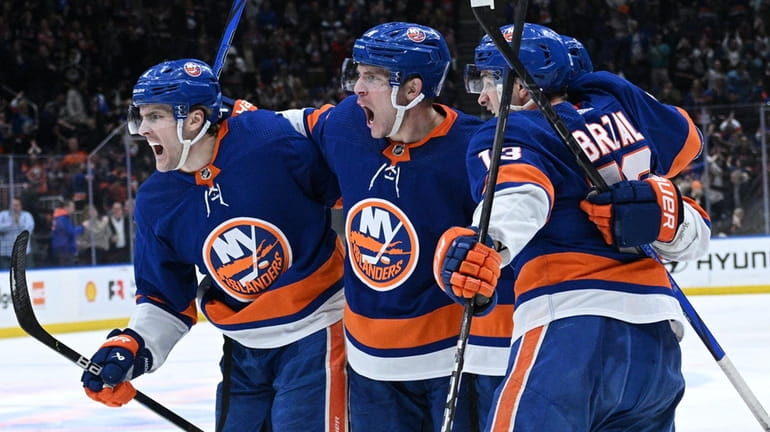 Islanders players celebrate a goal by center Casey Cizikas in...