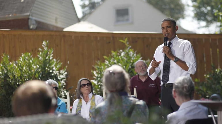 President Barack Obama speaks in the backyard of a private...