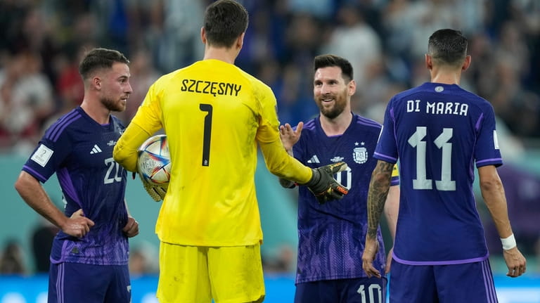 Argentina's Lionel Messi, second left, shakes hands with Poland's goalkeeper...