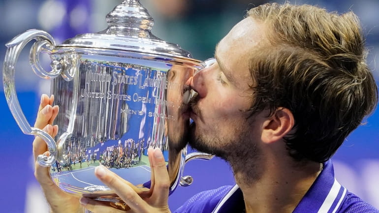 Daniil Medvedev, of Russia, kisses the championship trophy after defeating...
