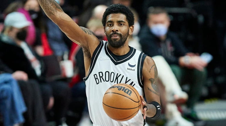 Nets guard Kyrie Irving gestures during the first half of...