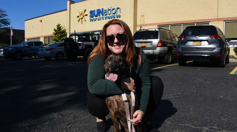 SUNation Solar Systems employee Victoria Walker with her adopted rescue...