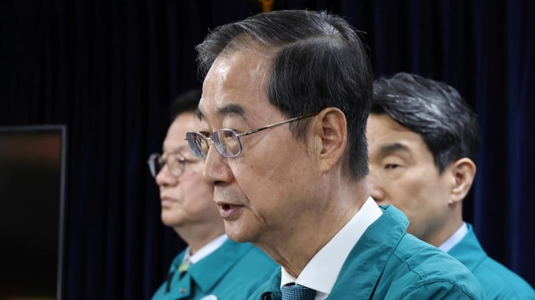 South Korean Prime Minister Han Duck-soo speaks during a briefing...