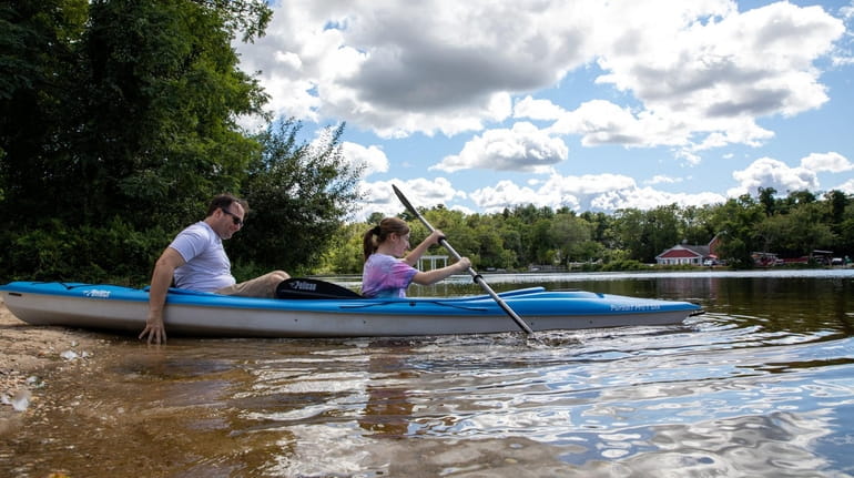 Rick Caskey and Abby Caskey, 13, enjoy kayaking on Upper...