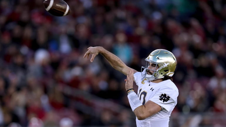 Notre Dame quarterback Sam Hartman throws a pass against Stanford...