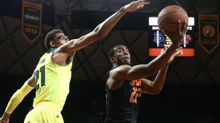 Oklahoma State guard Markel Brown, right, scores over Baylor center...