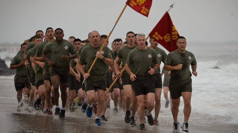 Members of the 2nd Marine Division, 2nd Tank Battalion run...